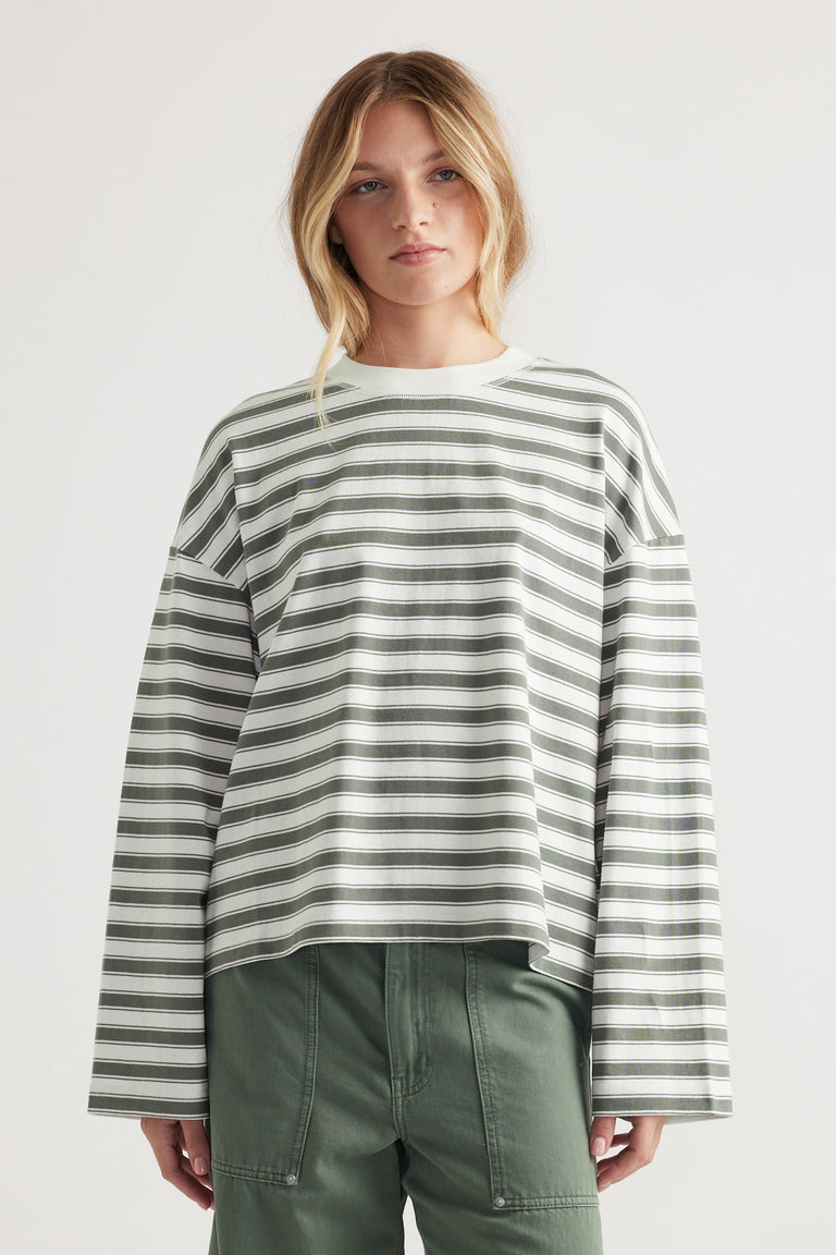 Relaxed fit long sleeve tee with green and white horizontal stripes and drop shoulder styling on model