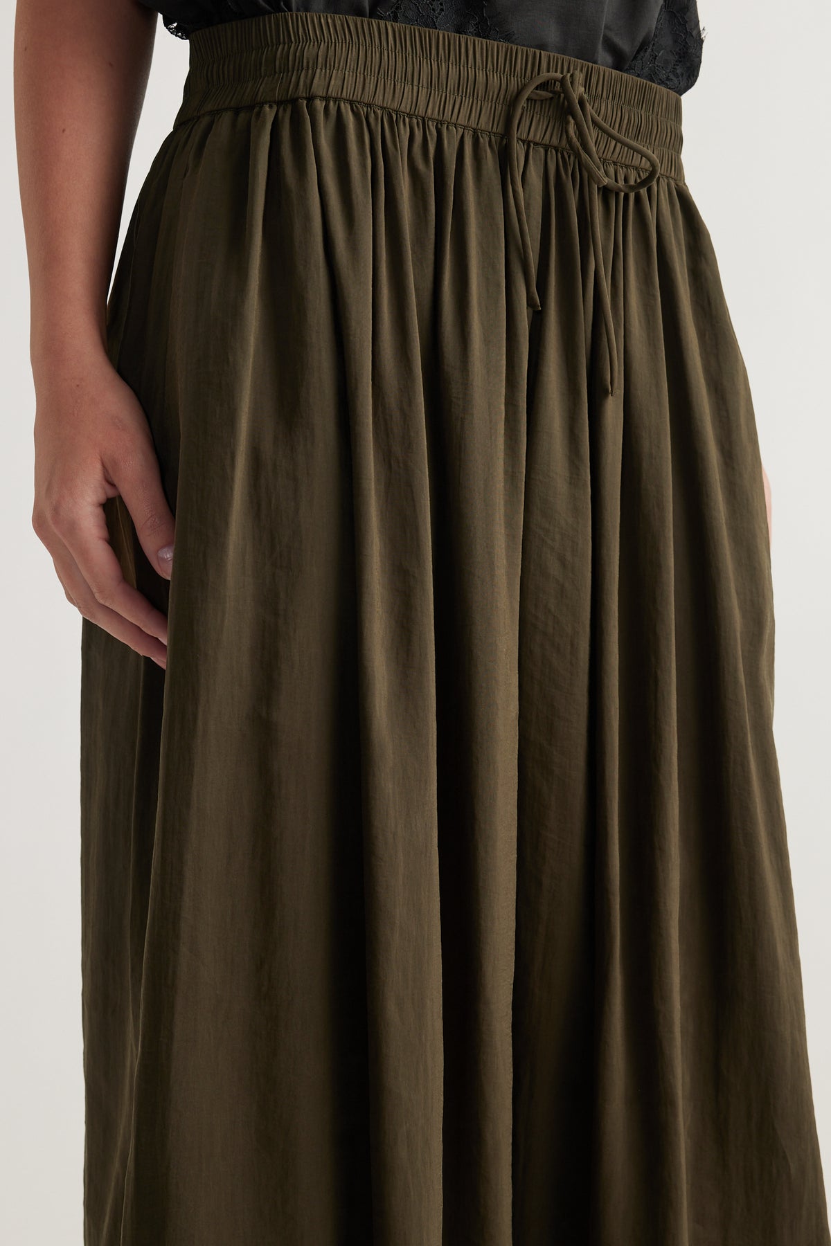 Olive balloon pants with an elasticated drawstring waist and full length wide legs