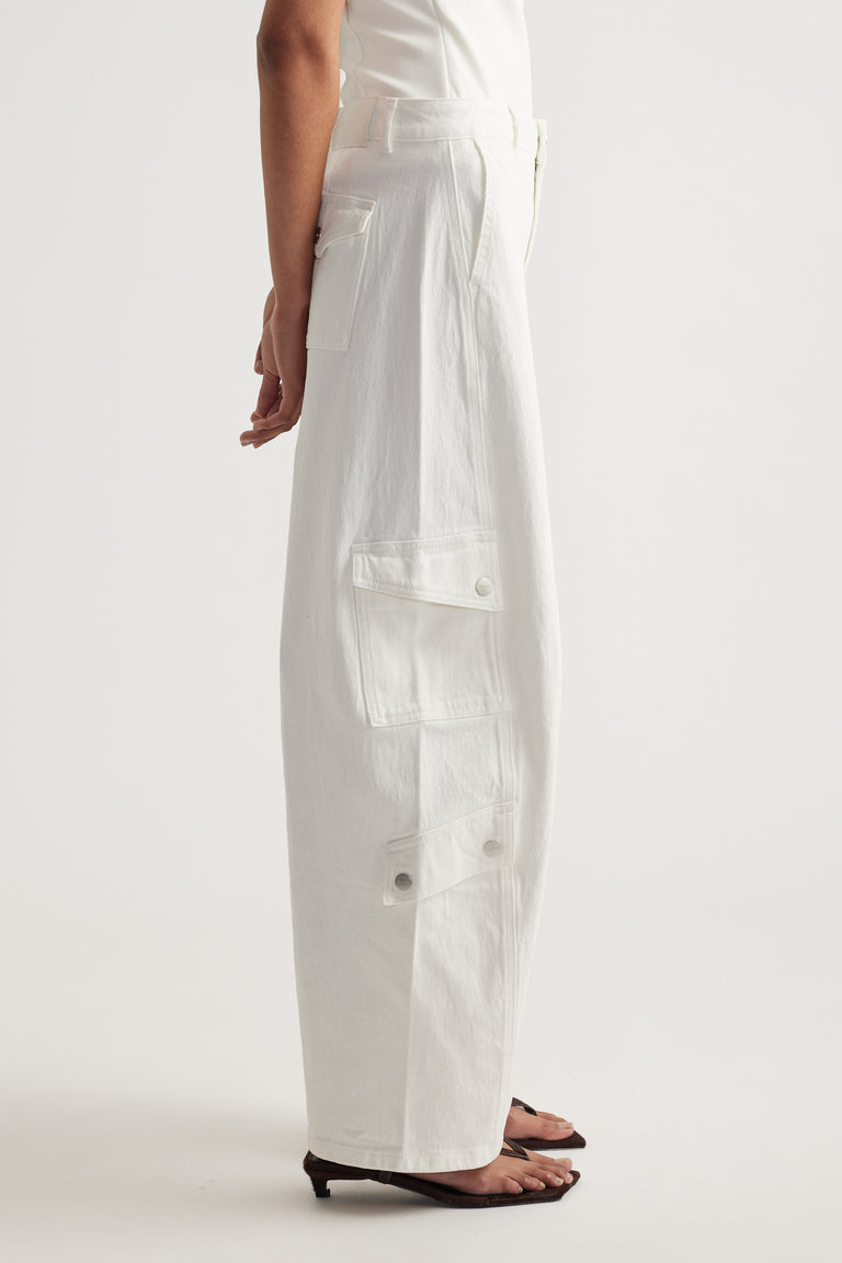 Model wearing white high-rise barrel-leg cargo jeans with multiple utility pockets and a full-length fit
