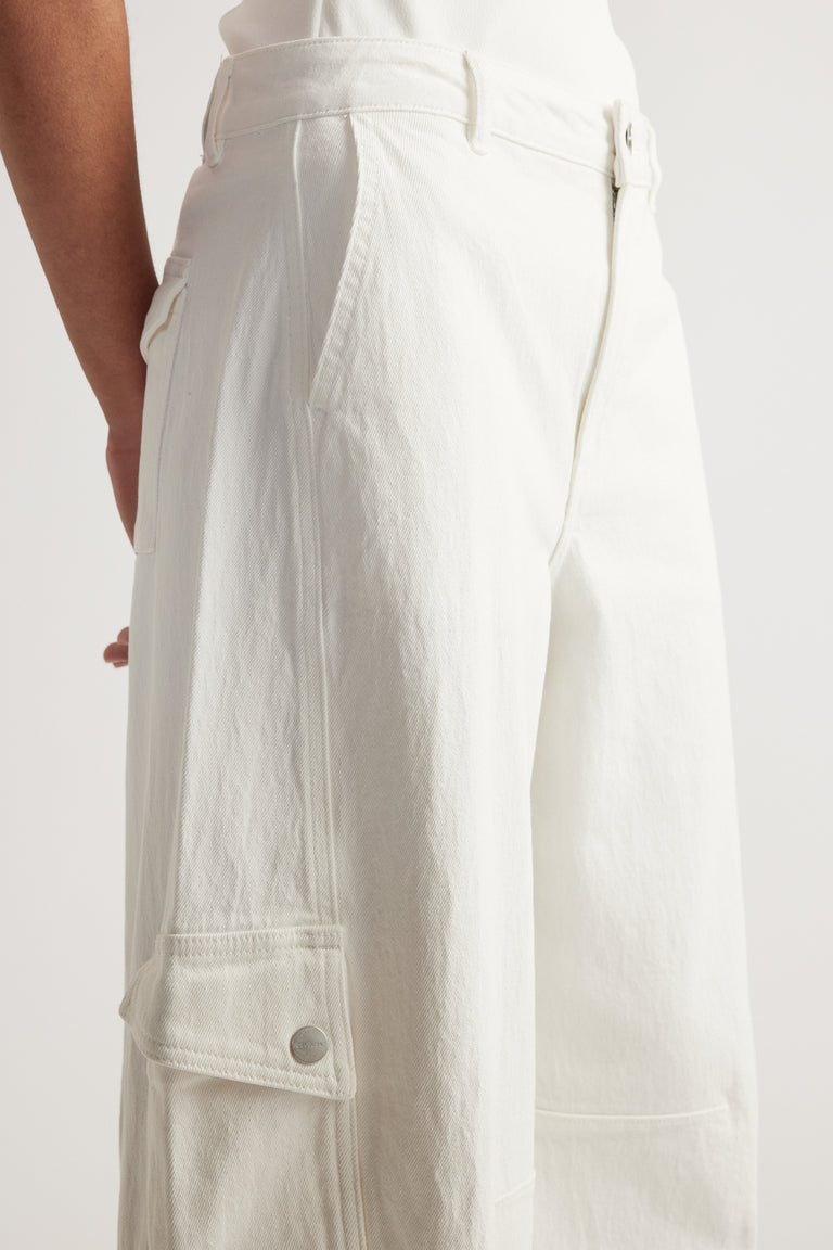 Close up of white cargo barrel leg jeans with a high rise waist, side pockets and buttoned utility pocket
