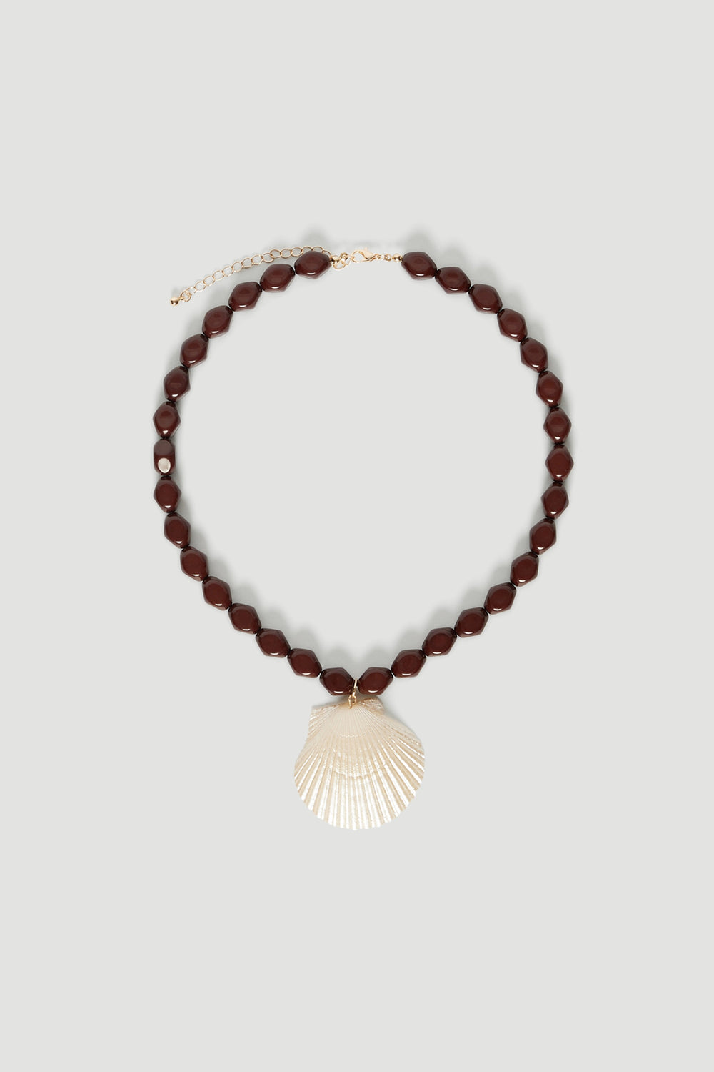 Chocolate brown stone necklace with a delicate shell pendant