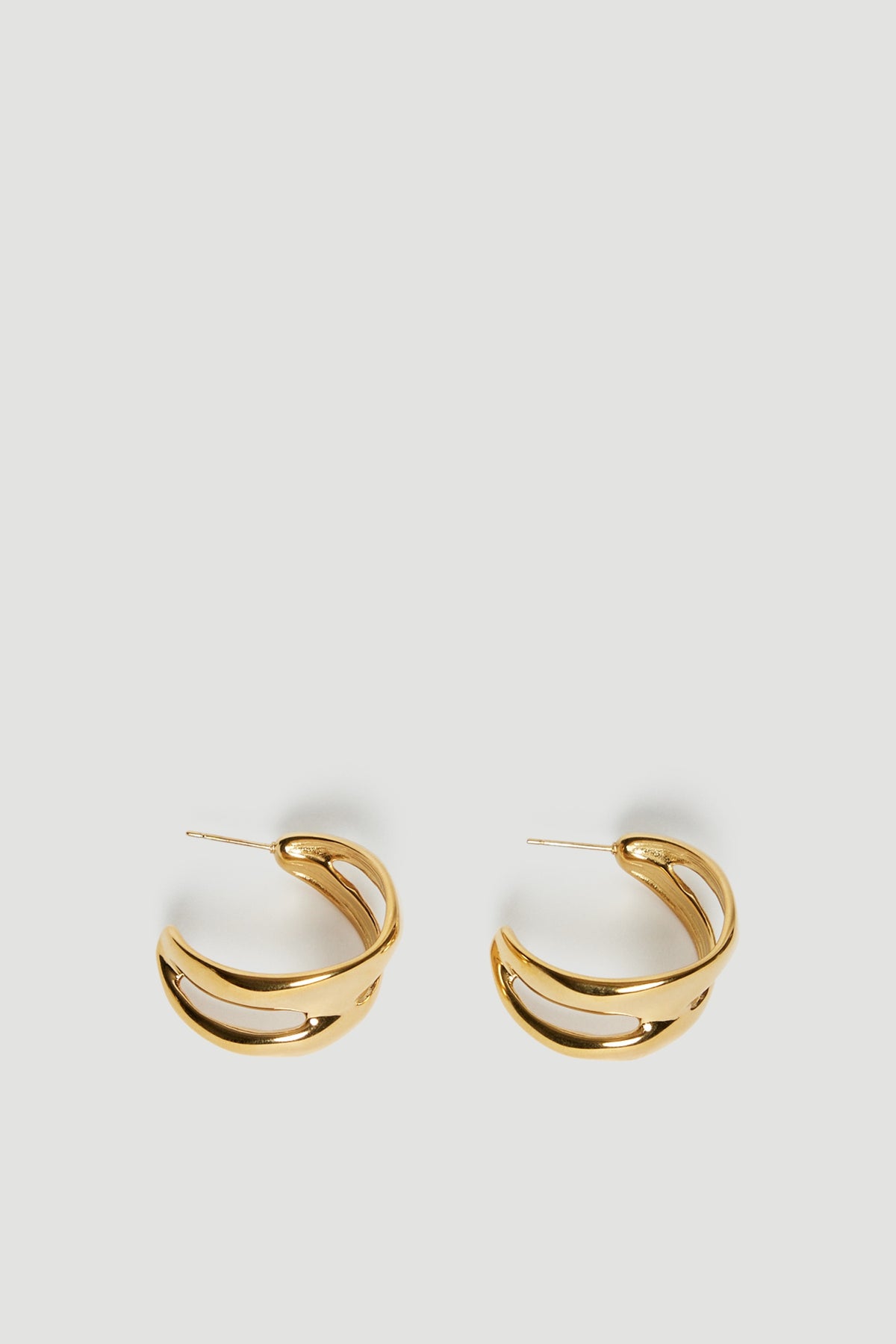 Pair of 18ct gold waterproof half moon hoop earrings on a light background