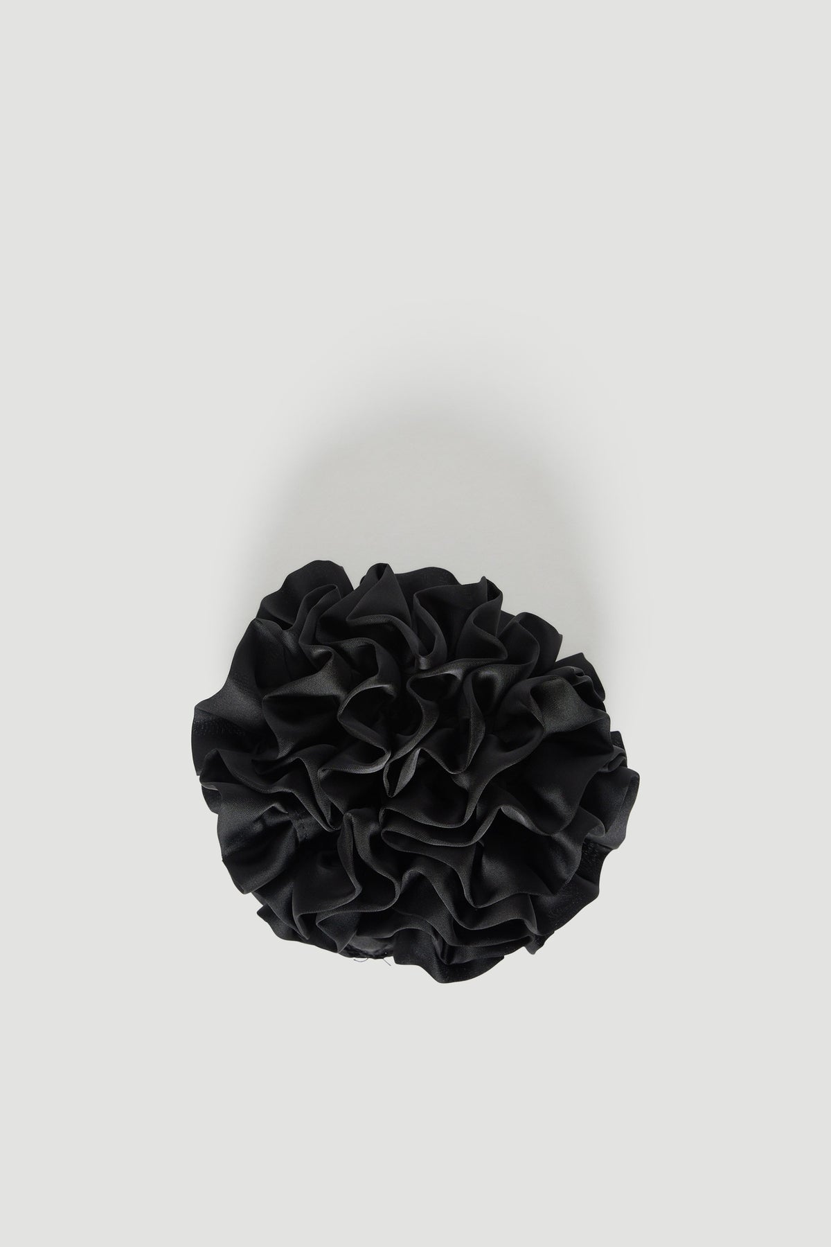 Black tiered ruffled scrunchie on a light background