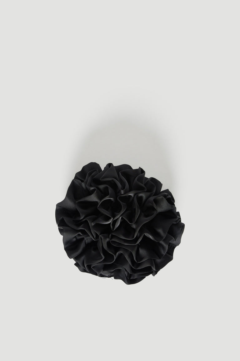 Black tiered ruffled scrunchie on a light background