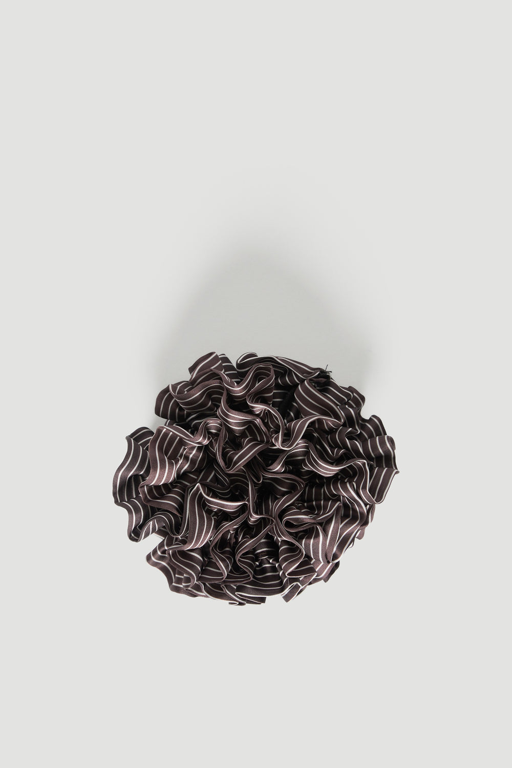 Dark striped tiered ruffled scrunchie on a light background