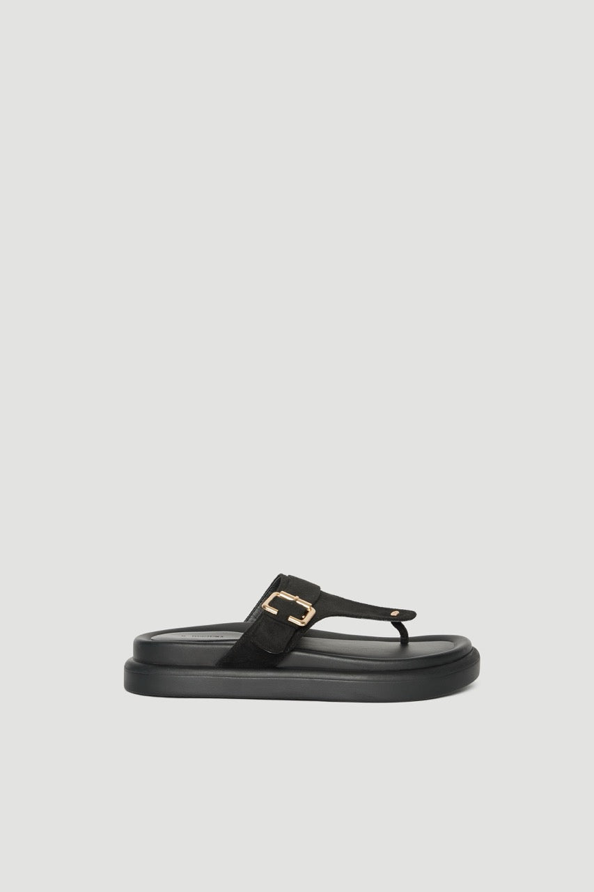 Black thong slide sandal with a buckled upper, gold hardware and a padded footbed