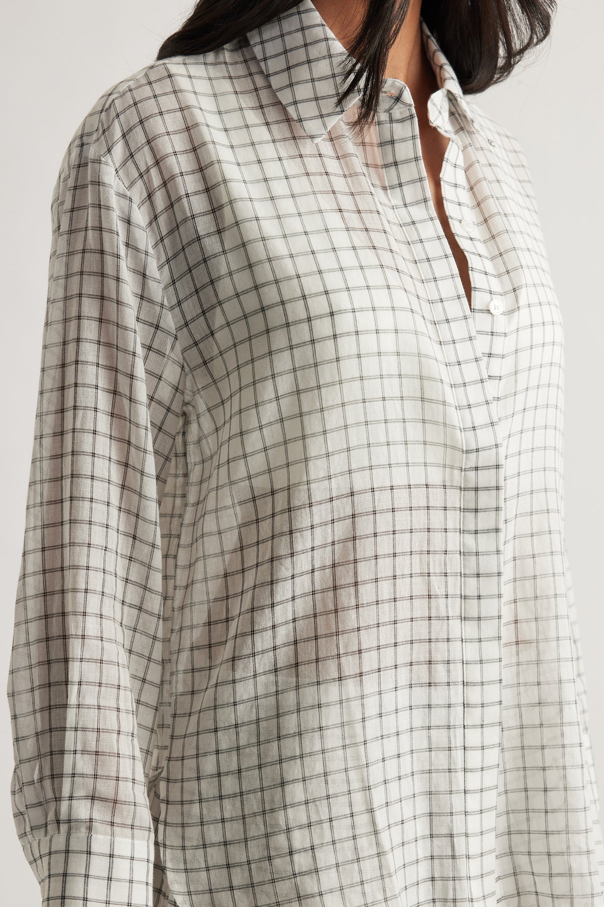 Model wearing an oversized cream check shirt with a collared neckline, long sleeves and button front