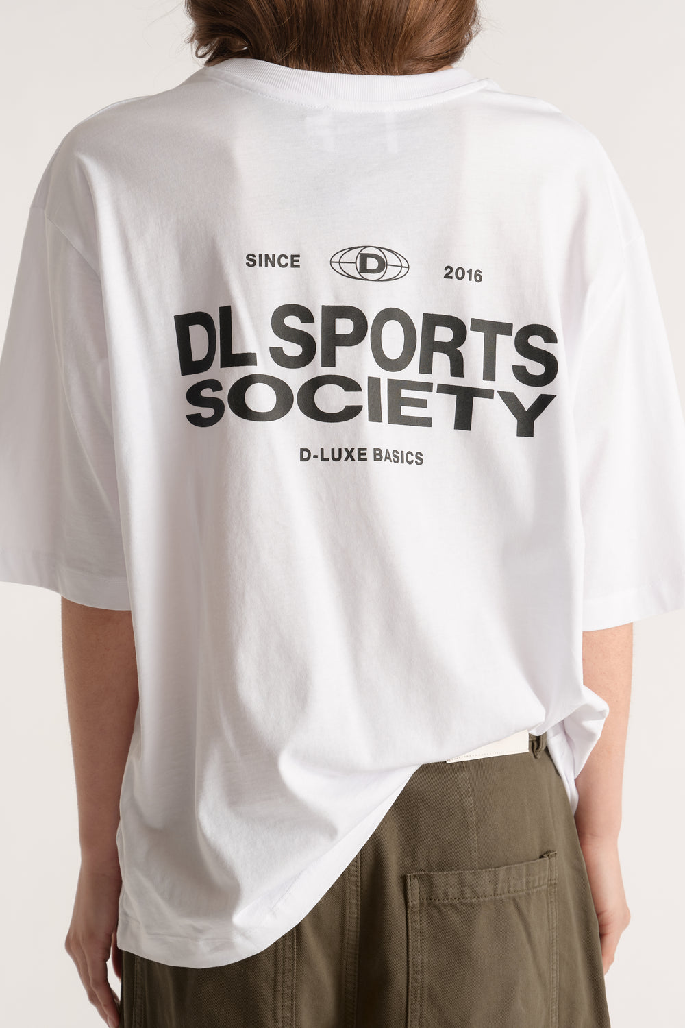 White relaxed fit tee featuring a bold black D-Luxe Sports Society back graphic