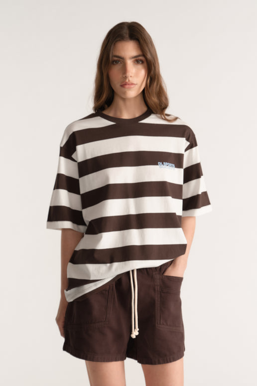 Woman wearing a relaxed brown and cream striped tee with dark brown drawstring shorts