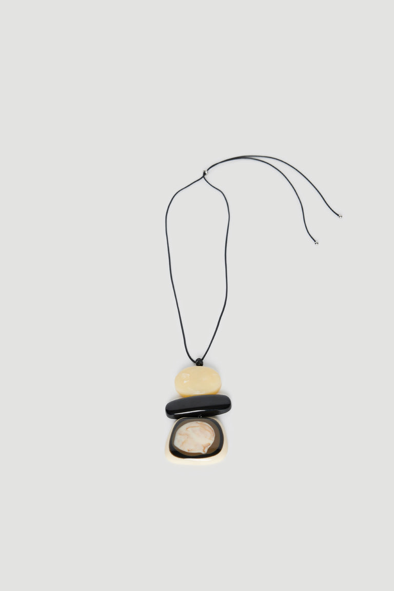 Statement cord necklace with three large pebble beads in black, cream and yellow