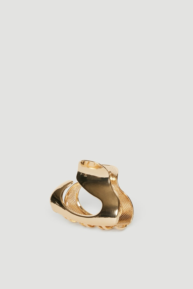 Gold sculptural oval hair claw clip with a high shine finish