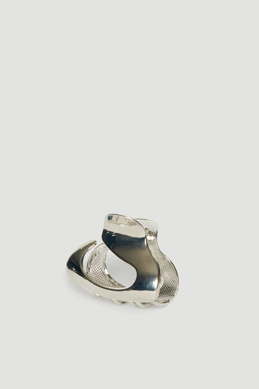Small silver oval hair claw with a sculptural design and high shine finish