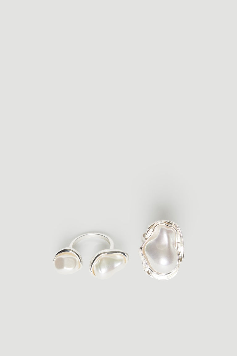Two pearl rings with uneven textured bands in different sizes and a lightweight design