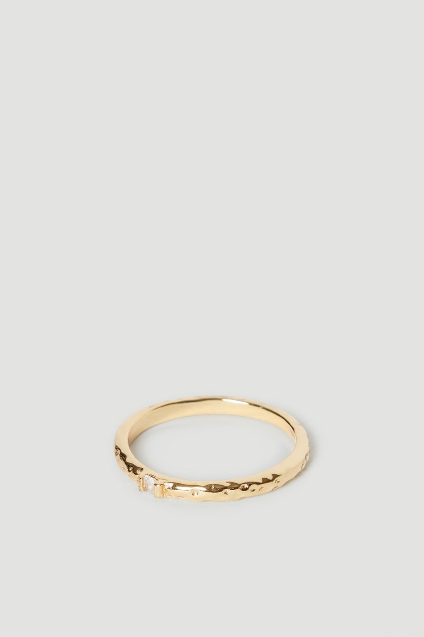 Slim gold single band ring with a subtle textured finish