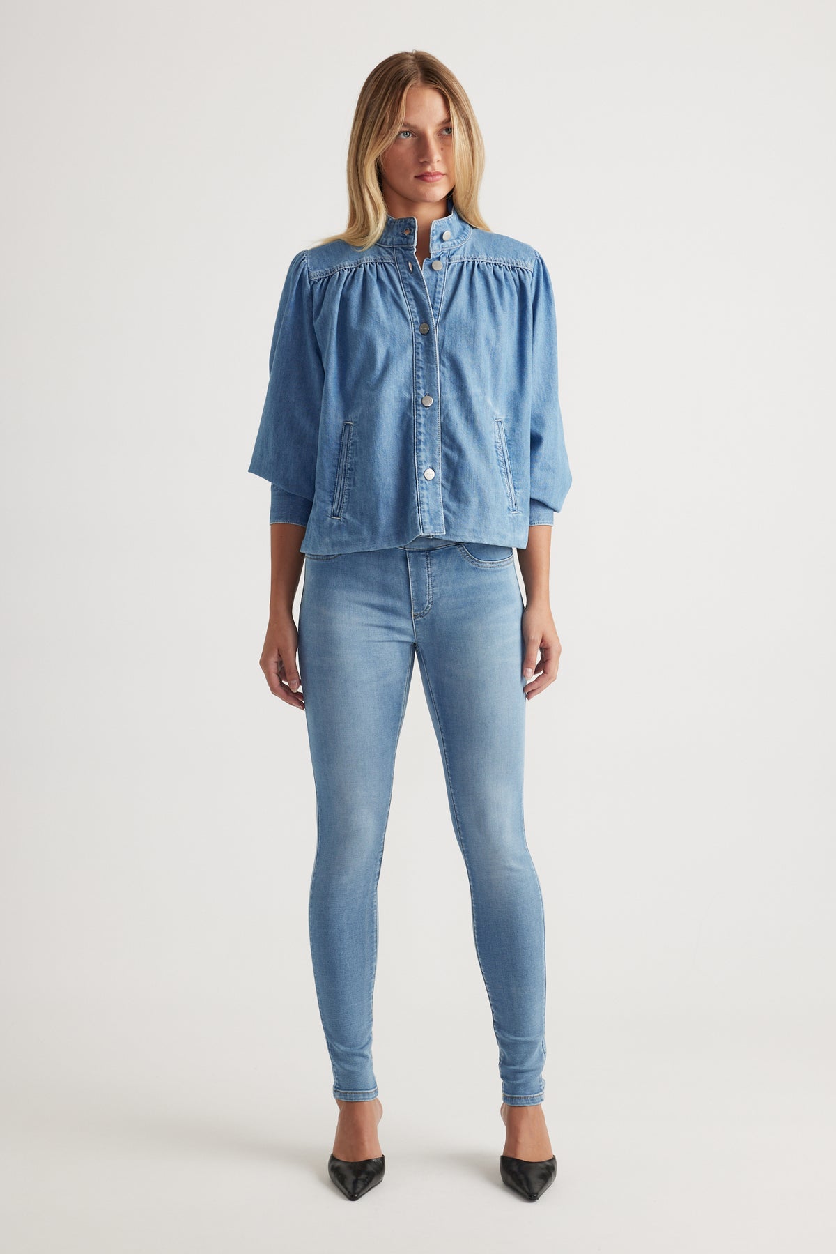 Front view of model wearing Riley Skinny Jean in light blue denim paired with loose denim top by Decjuba Australian brand