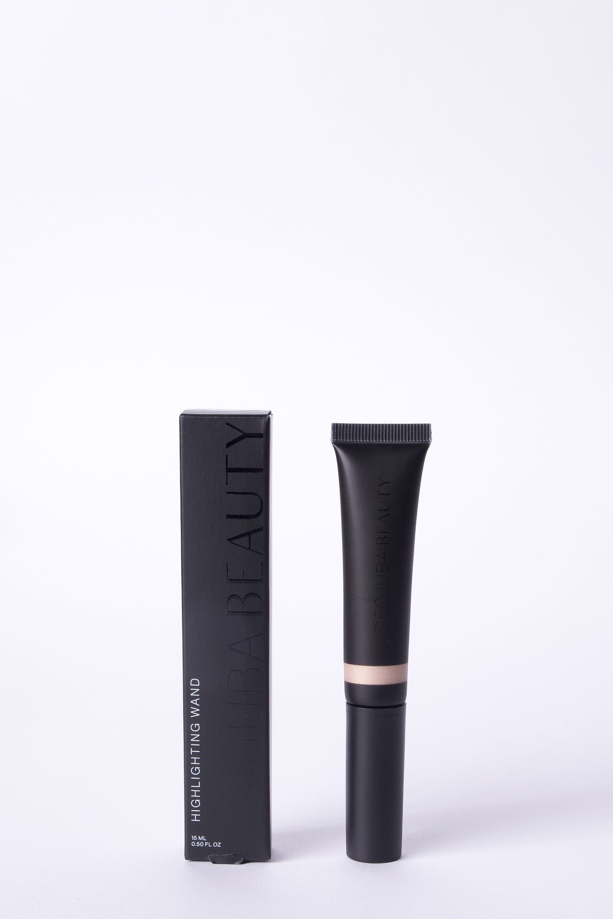 Black highlighting wand makeup tube and box beside each other