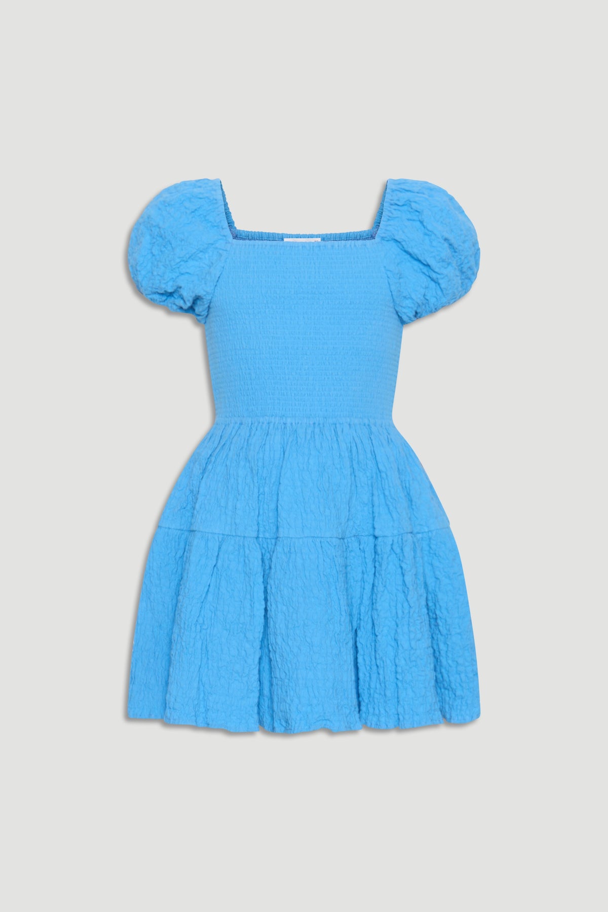 Bright blue girls mini dress with puffed sleeves, smocked bodice, and textured tiered skirt for playful style.