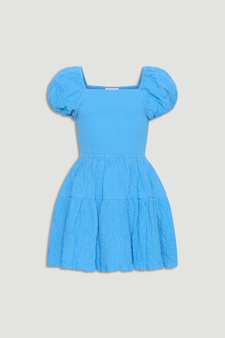 Bright blue girls mini dress with puffed sleeves, smocked bodice, and textured tiered skirt for playful style.