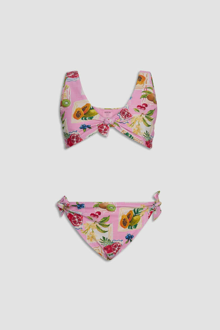 Pink girls bikini set with tropical fruit print, featuring a front knot top and side tie bottoms.