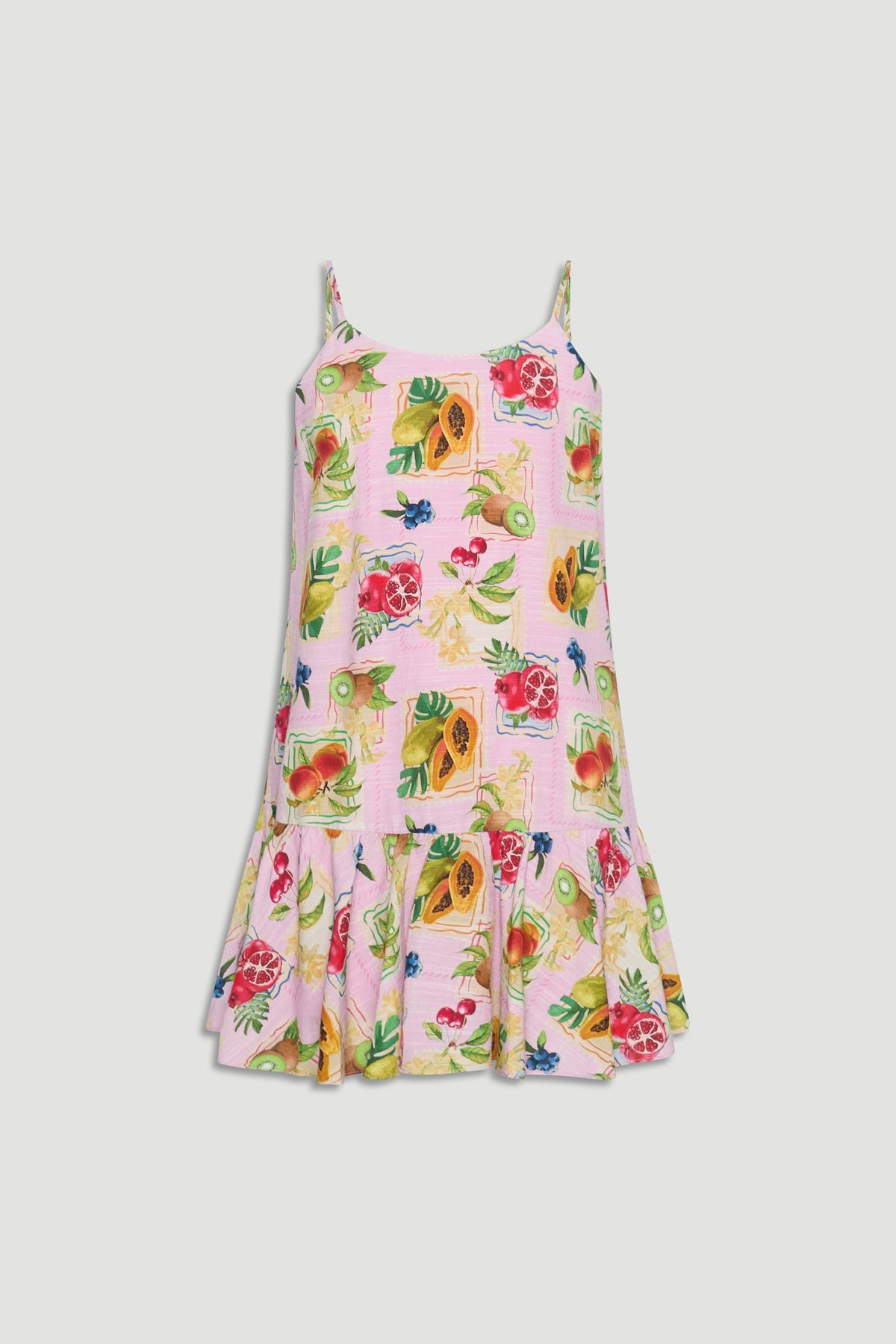 Light pink girls dress with thin straps and colorful tropical fruit prints, featuring a flared hem detail.