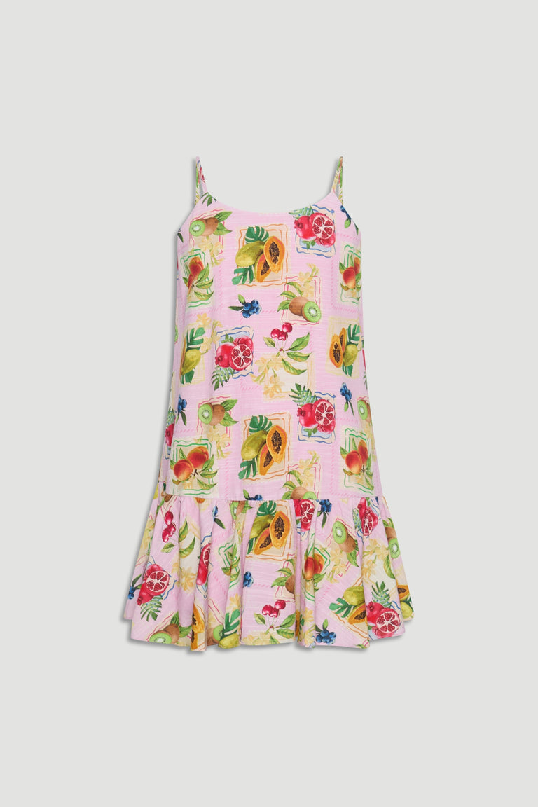 Light pink girls dress with thin straps and colorful tropical fruit prints, featuring a flared hem detail.