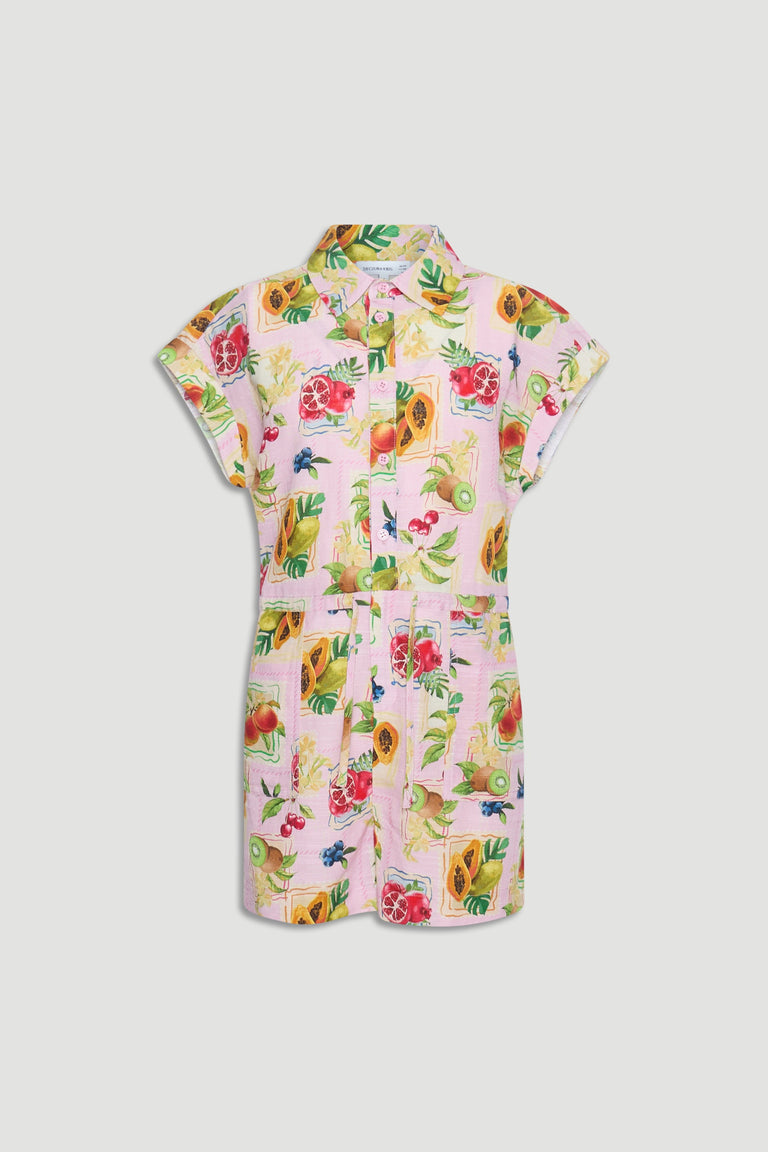 Girls playsuit in pastel pink featuring a vibrant tropical fruit print with short sleeves and a collar neckline