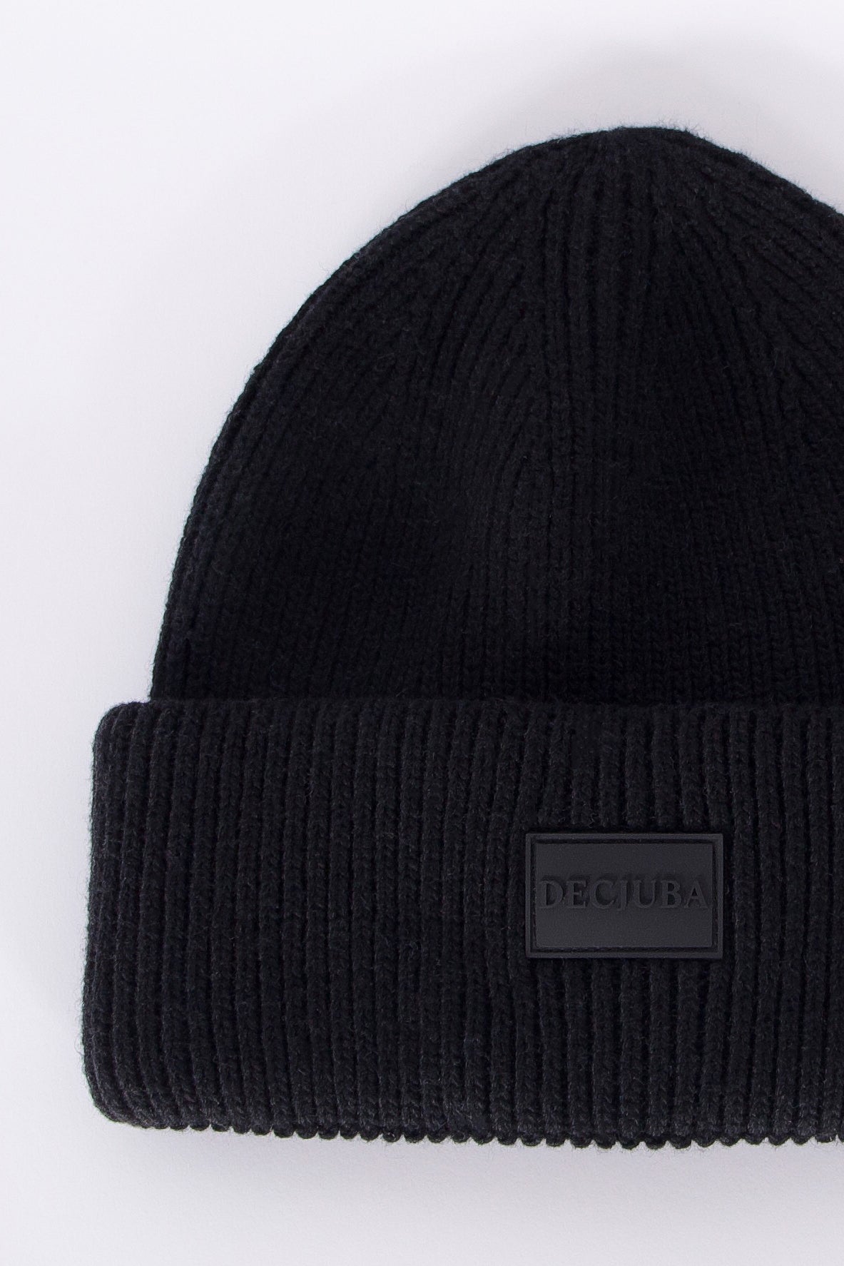 Black ribbed knit beanie with folded cuff featuring a minimalist branded patch, cozy and versatile design for girls.