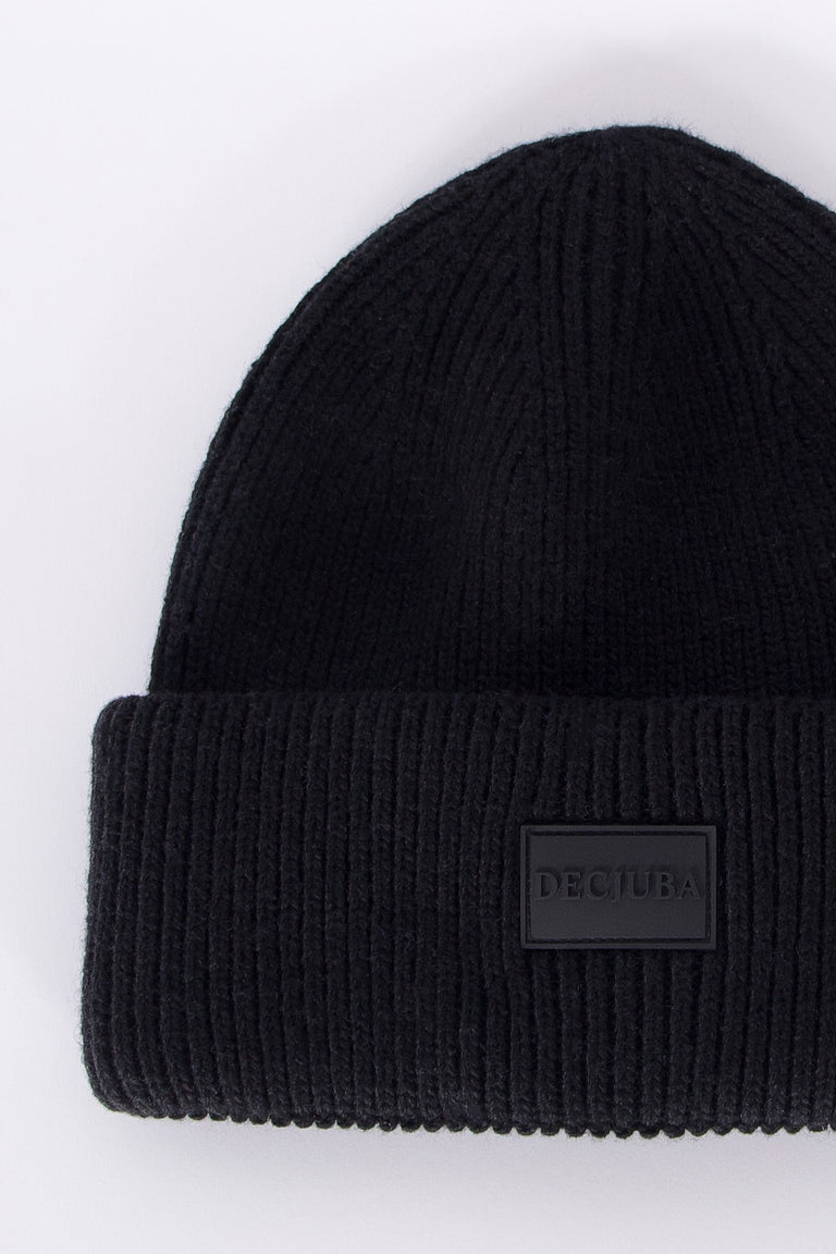 Black ribbed knit beanie with folded cuff featuring a minimalist branded patch, cozy and versatile design for girls.