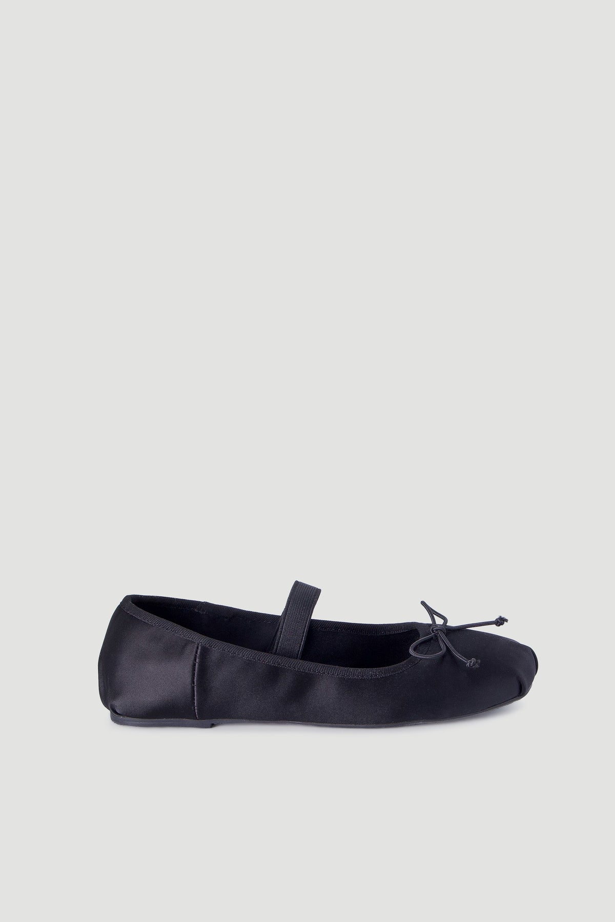 Black satin ballet flat for girls with a slim strap and delicate bow detail for everyday elegance