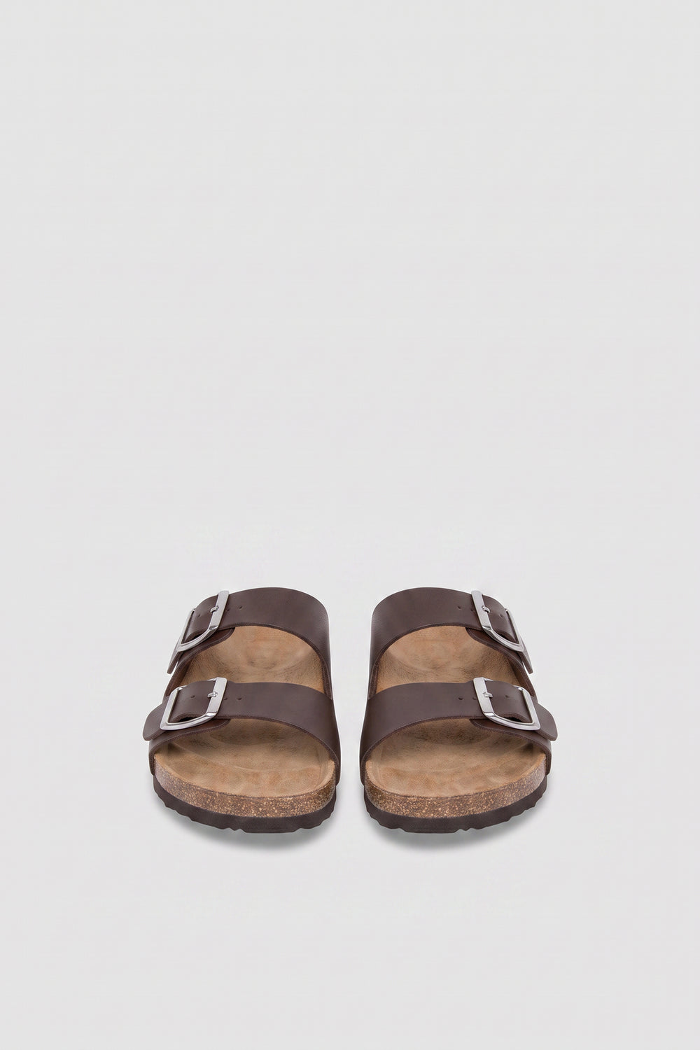 Pair of girls brown flat sandals with double buckle straps, silver hardware and cork soles