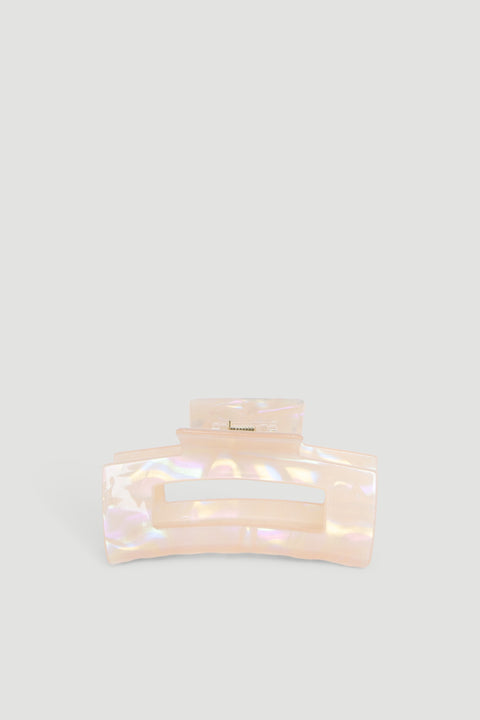 Iridescent peach-colored hair claw with a wide grip, designed for securing hair effortlessly.