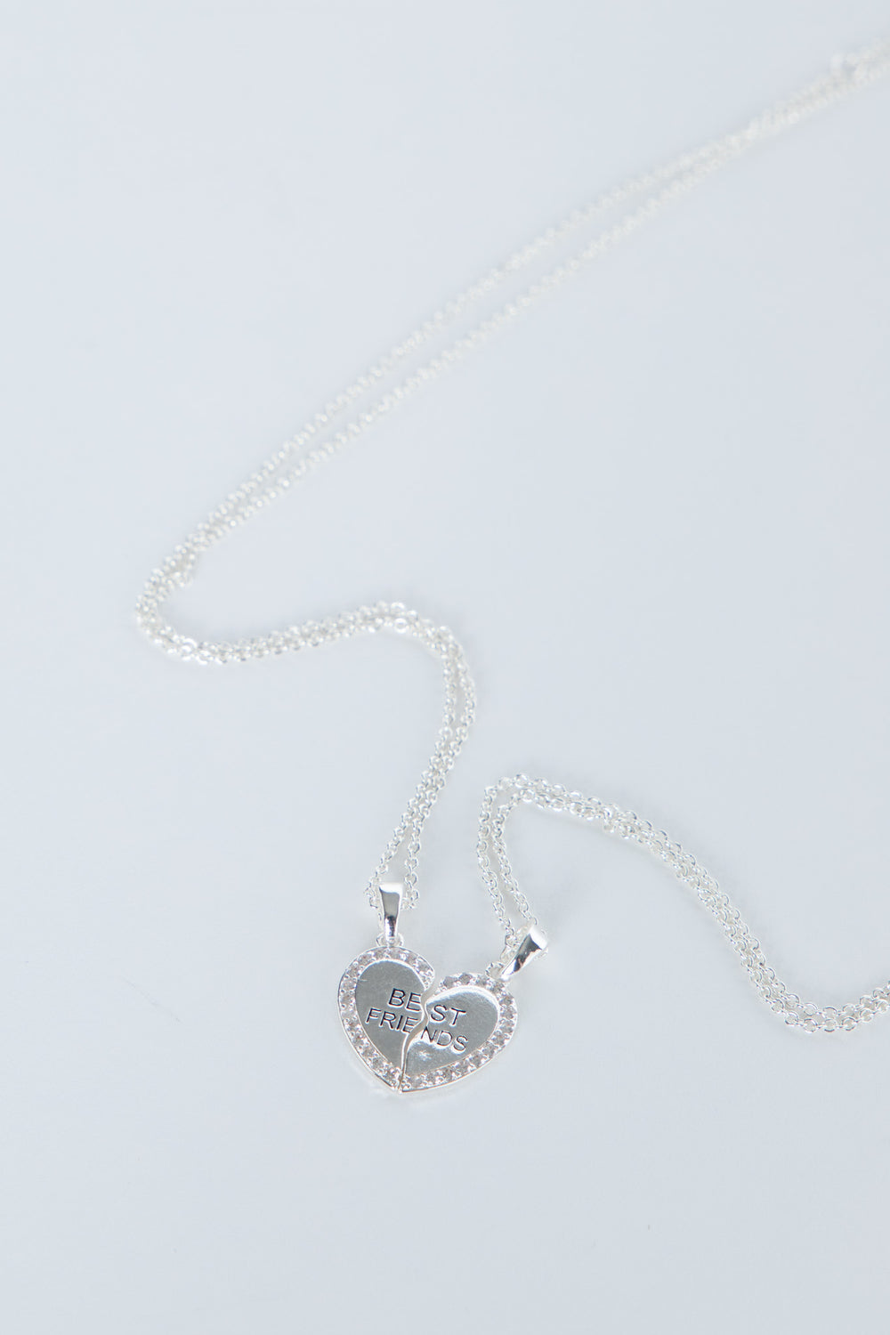 Delicate silver-tone heart pendant split into two best friends charms on matching fine chains