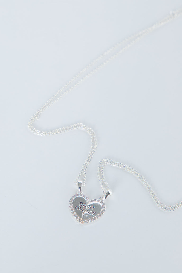 Delicate silver-tone heart pendant split into two best friends charms on matching fine chains