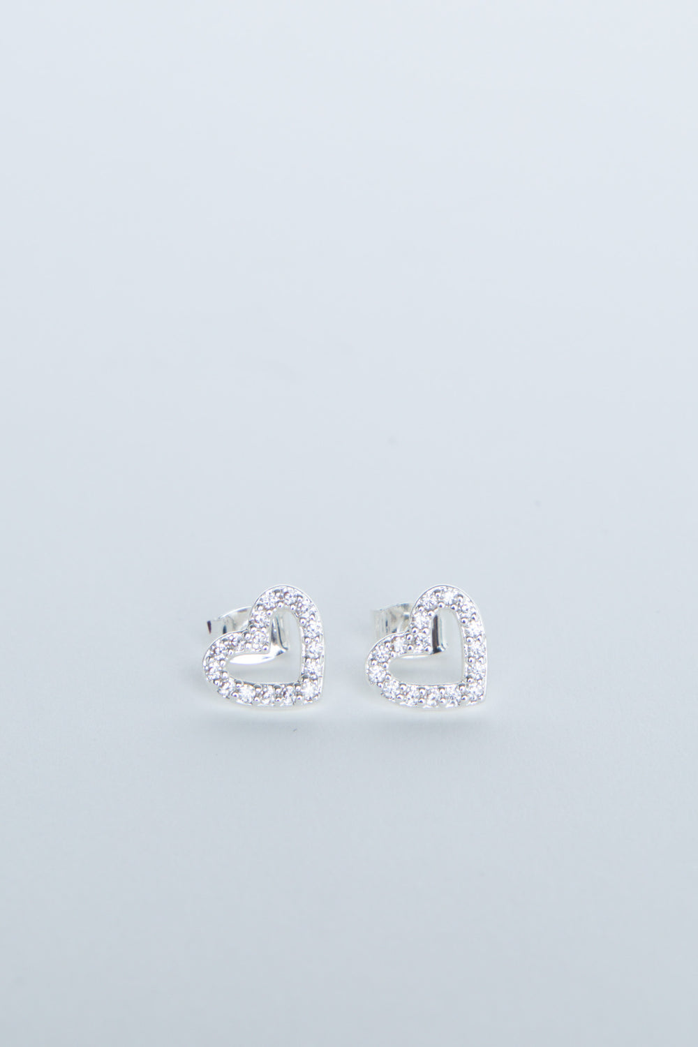 Heart-shaped stud earrings with sparkling crystal detailing