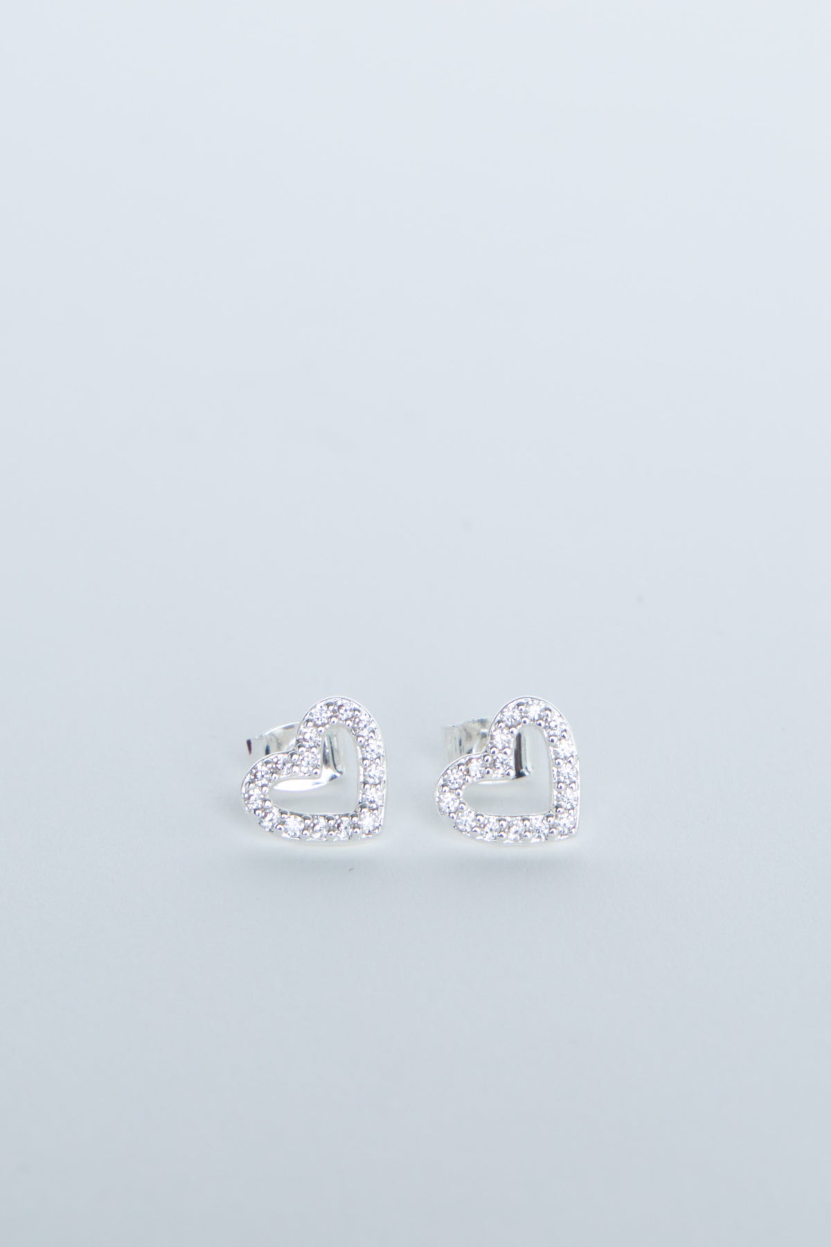 Heart-shaped stud earrings with sparkling crystal detailing