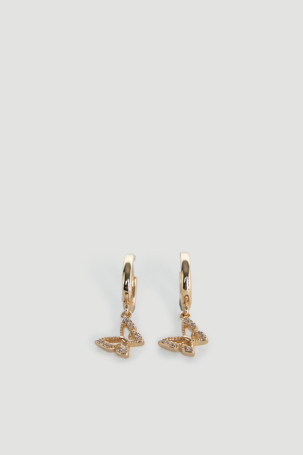 Delicate 9ct gold hoop earrings featuring small butterfly charms with subtle textured detailing.