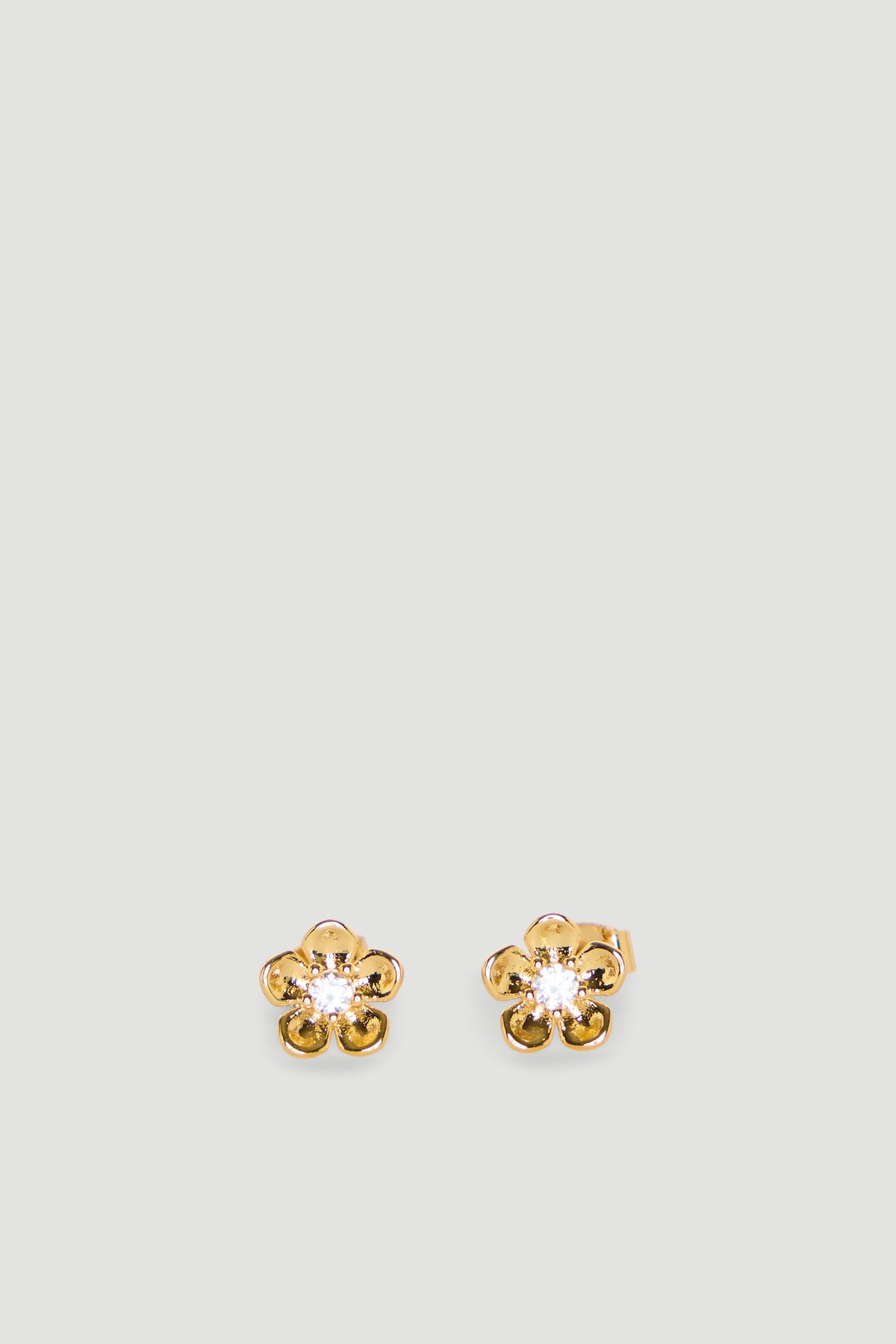 Delicate gold flower-shaped stud earrings with a sparkling center detail, perfect for girls’ everyday wear.