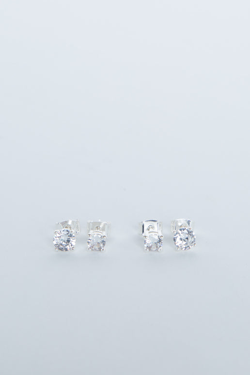 Two pairs of delicate silver stud earrings with sparkling clear stones, minimalist and elegant design for girls.