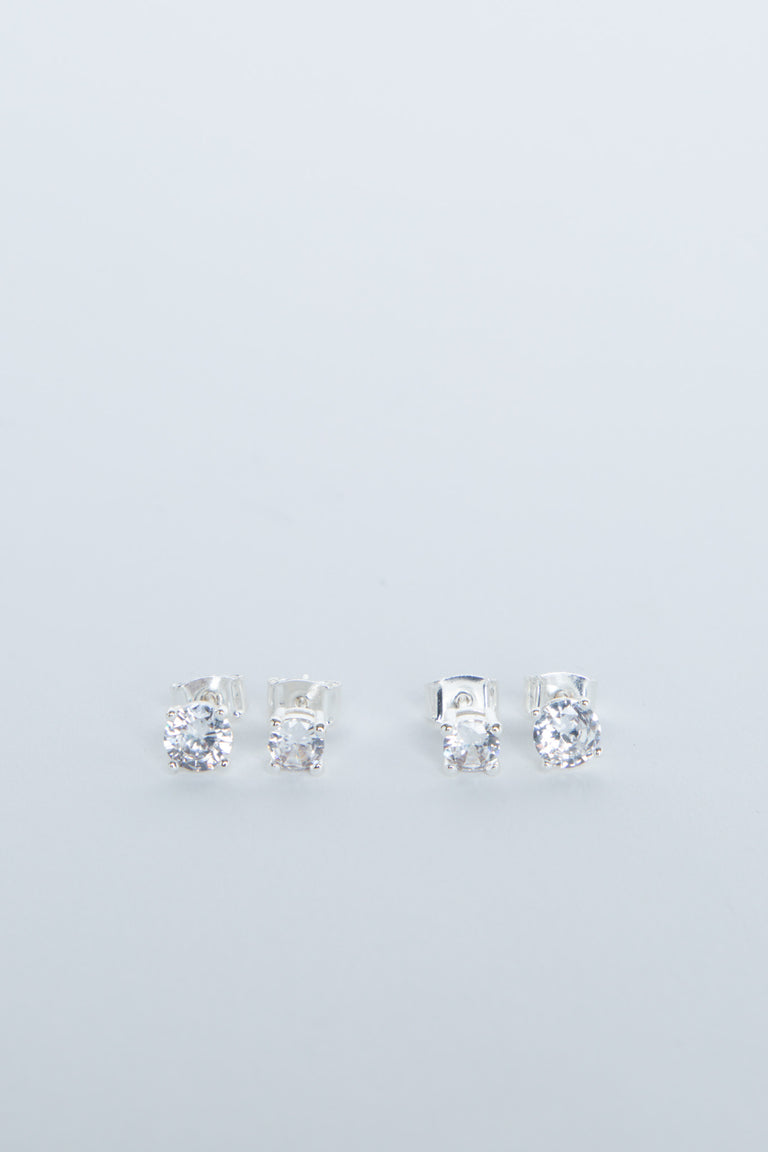 Two pairs of delicate silver stud earrings with sparkling clear stones, minimalist and elegant design for girls.
