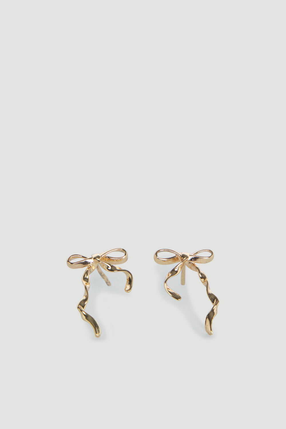 Delicate gold bow-shaped stud earrings with elegant twisting ribbon details for a charming, youthful look