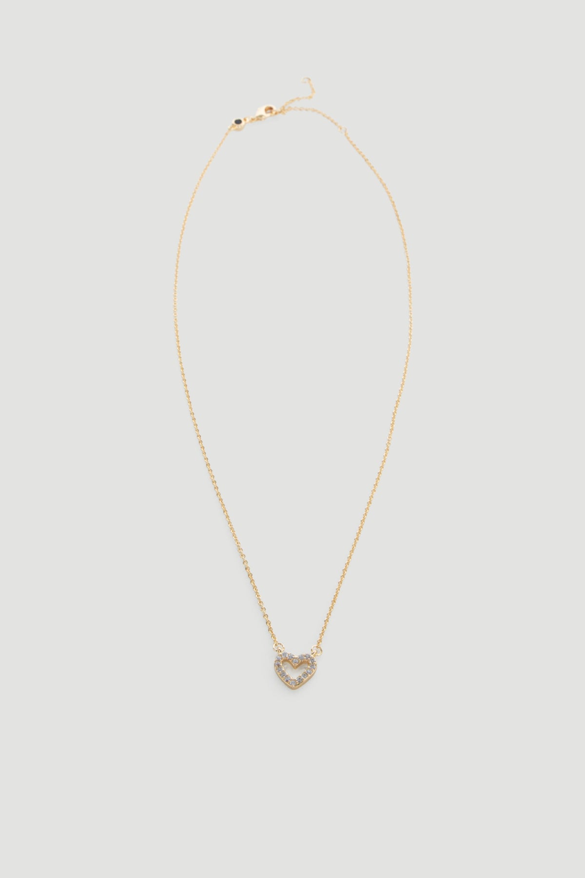 Delicate gold necklace featuring a small heart pendant adorned with sparkling stones for a subtle touch of elegance