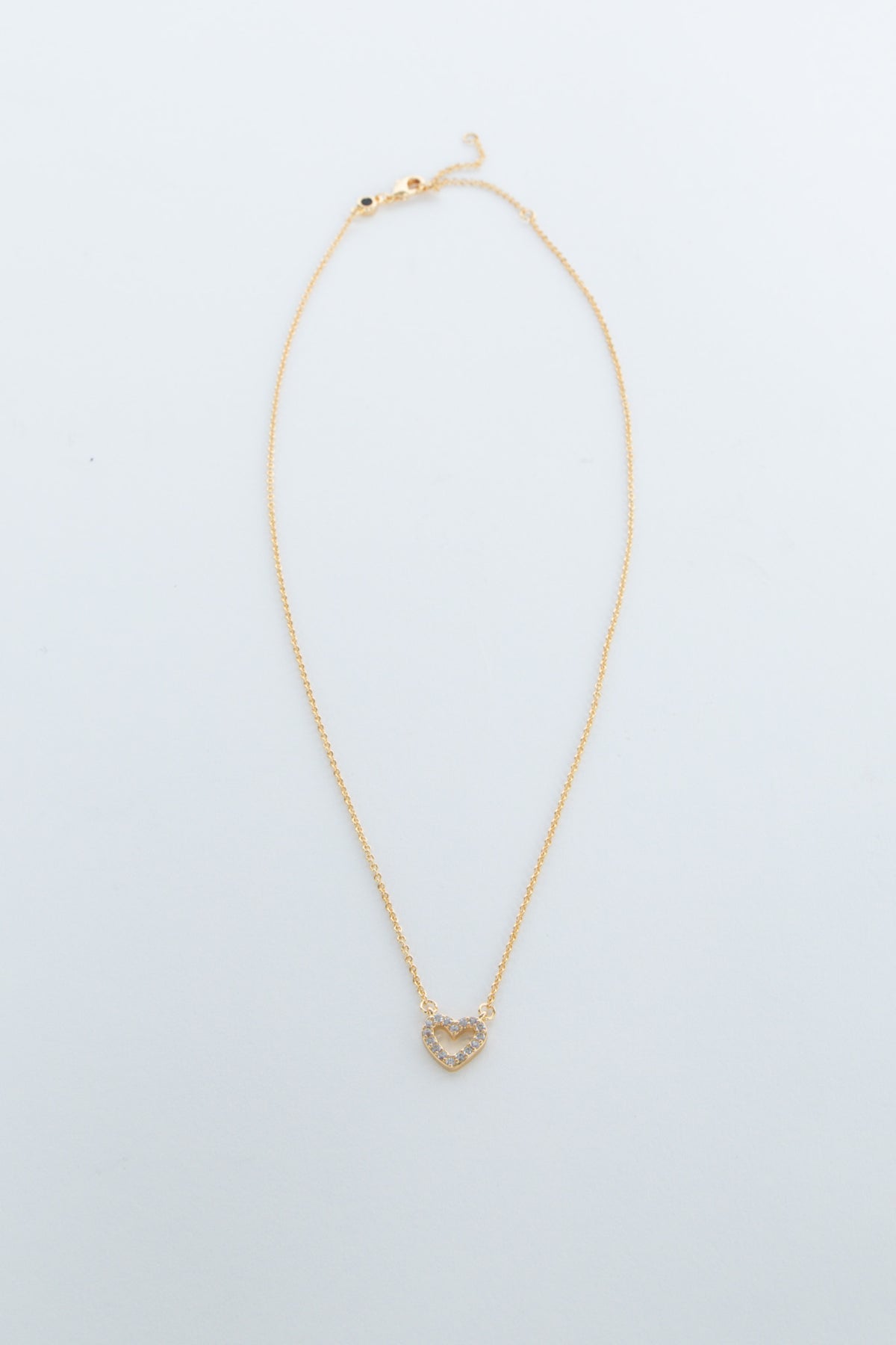 Delicate gold chain necklace featuring a small heart-shaped pendant with sparkling accents for girls.