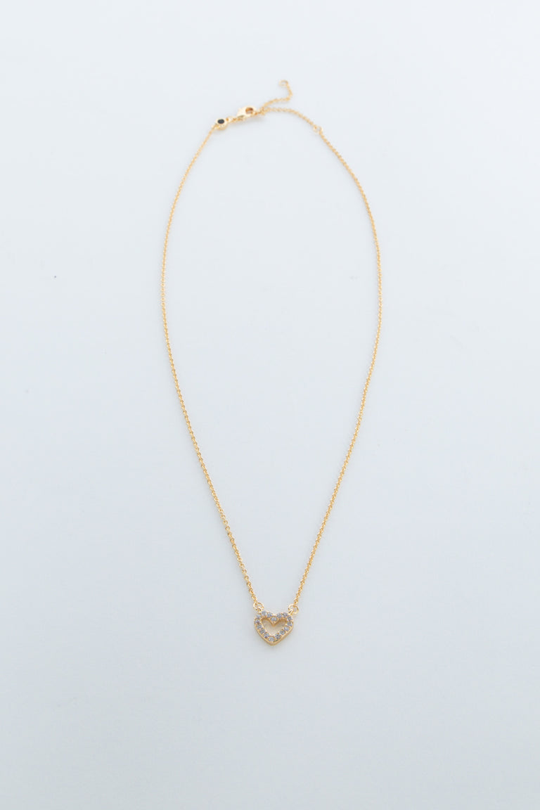 Delicate gold chain necklace featuring a small heart-shaped pendant with sparkling accents for girls.