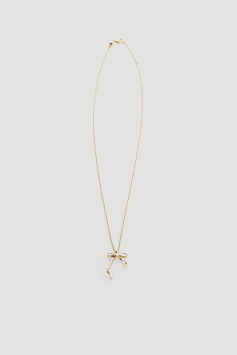 Delicate gold necklace featuring a dainty bow pendant on a fine chain, perfect for everyday wear.