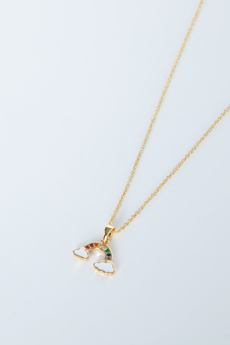 Delicate gold necklace featuring a small rainbow pendant with colorful stones and cloud accents on a fine chain