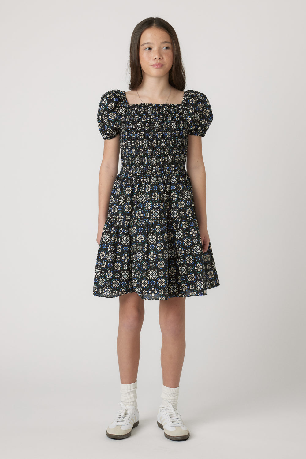 Girls Maude Mini Dress with short balloon sleeves and floral print, worn by model in portrait gallery position 1, 4060x6090px.