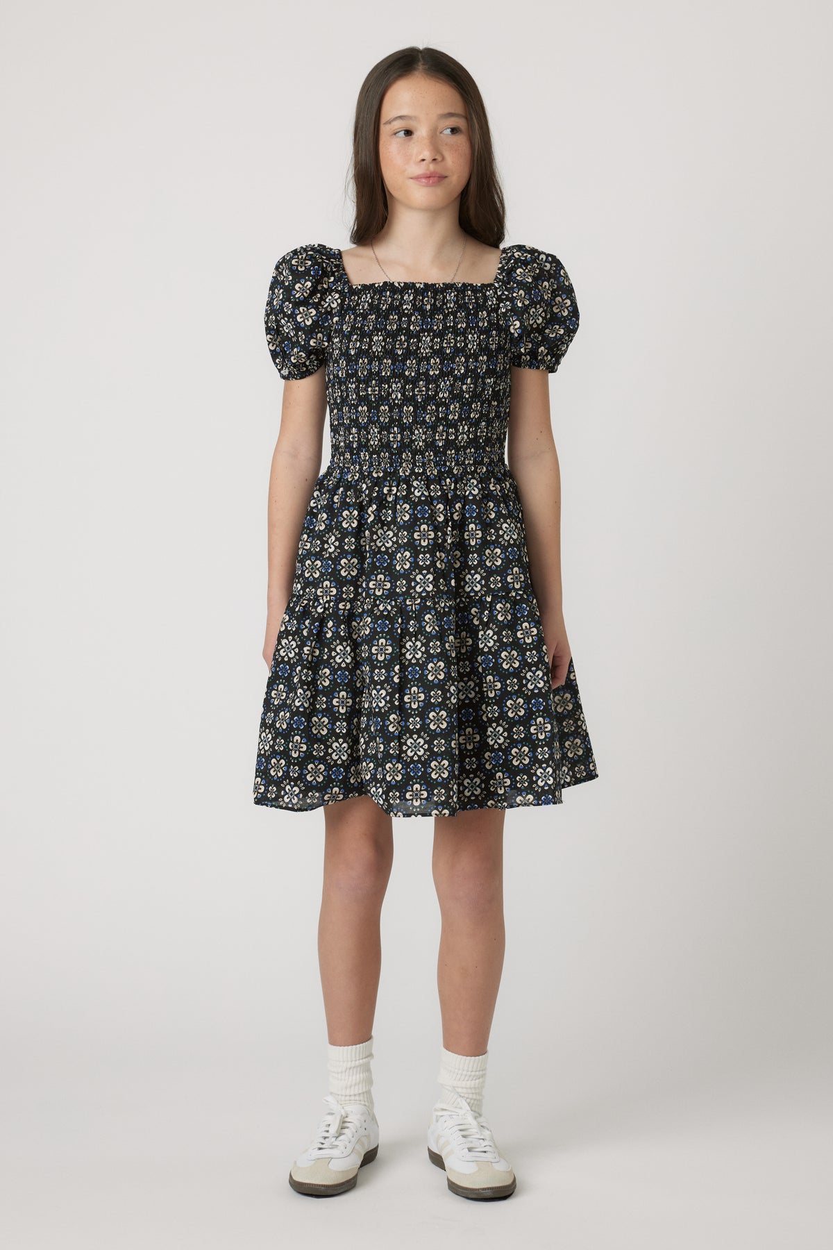 Girls Maude Mini Dress with short balloon sleeves and floral print, worn by model in portrait gallery position 1, 4060x6090px.