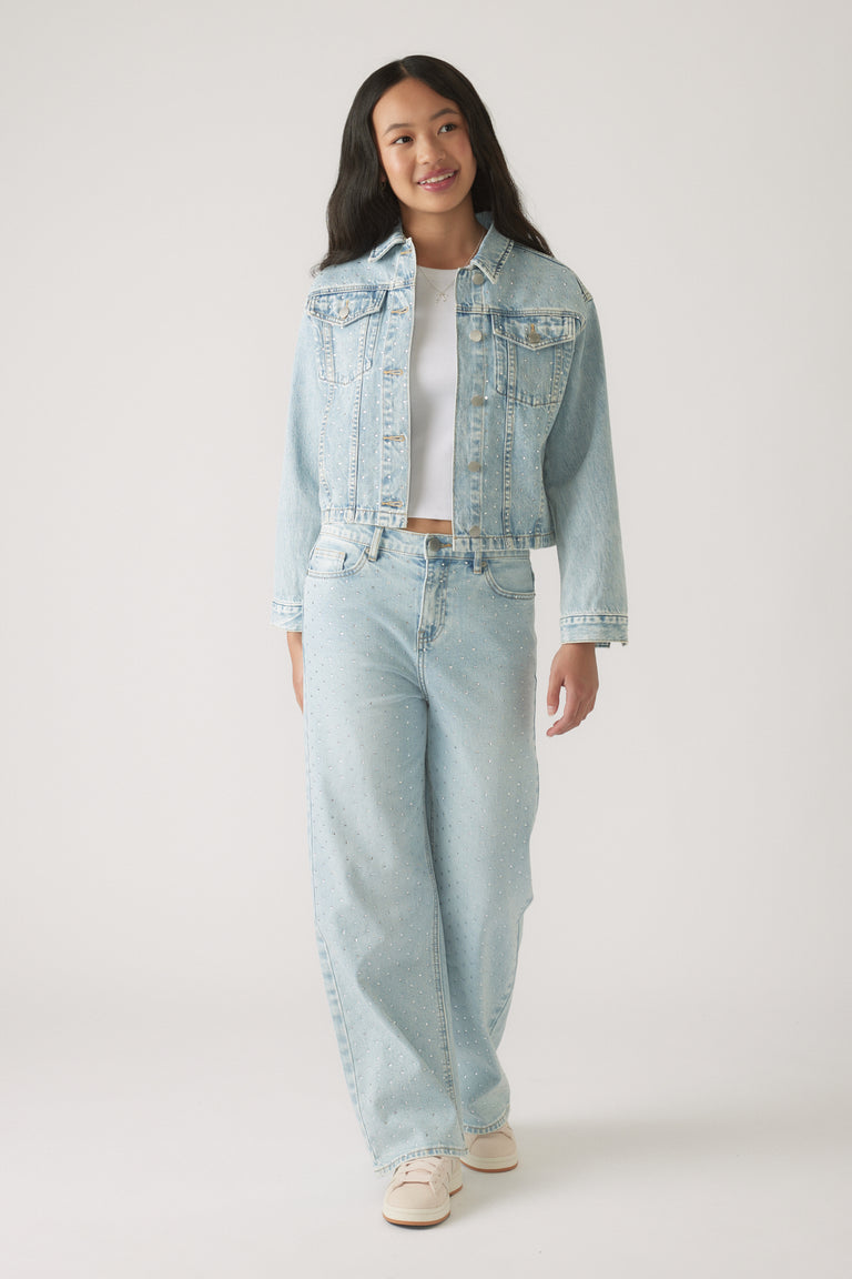 Girl wearing a Girls Embellished Denim Jacket paired with matching embellished wide-leg jeans and white sneakers