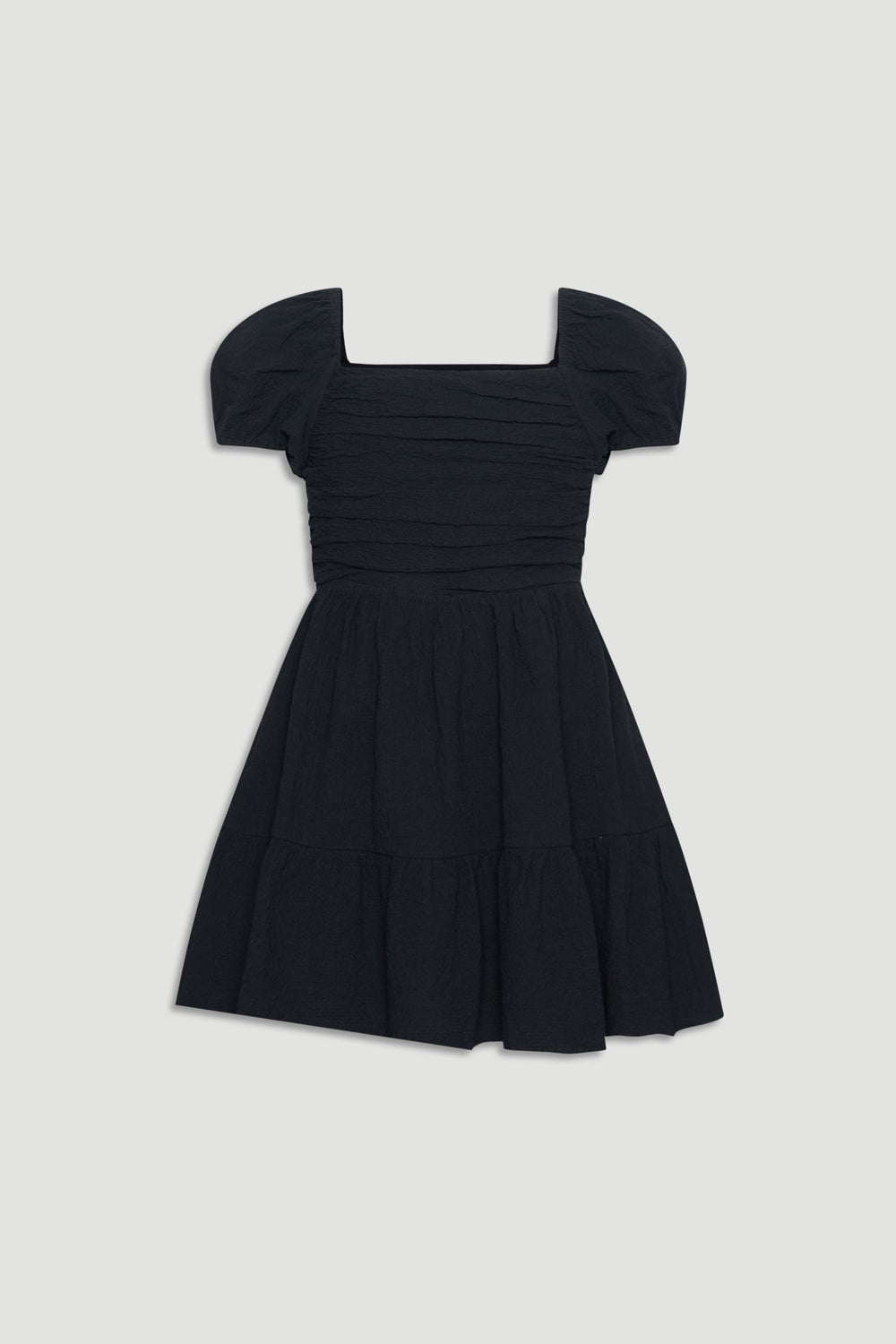 Black textured mini dress with puff sleeves and a gathered skirt for an easy, stylish girls' outfit.