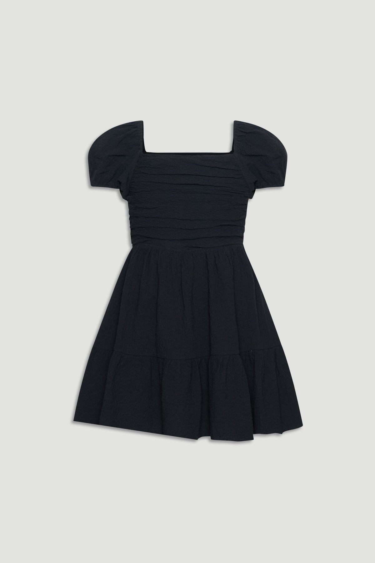 Black textured mini dress with puff sleeves and a gathered skirt for an easy, stylish girls' outfit.
